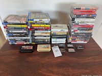 Overall shot showing three game stacks and handheld cartridges, confirming quantity and variety