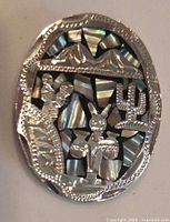 Front view of oval mosaic pin showing full design