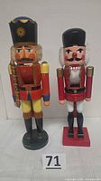 Front view of both nutcrackers side by side with lot number