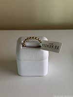 Ring on white display box with Ti Sento tag visible