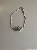 Full bracelet laid flat showing snake motif and chain