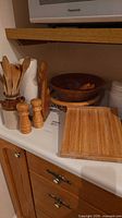 Group shot of utensils, mills, bowl, tray, board, canister