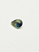 Pear-cut green-blue sapphire on white background