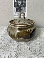 Stoneware jar with lid closed, showing glaze colors