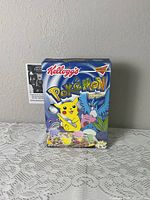 Front of sealed Kellogg's Pokémon cereal box with Pikachu and assorted Pokémon graphics