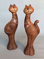 Front view of both clay cat figurines