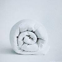 Rolled white duvet standing upright