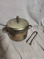 Lidded silver-plated ice bucket and tongs