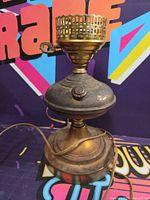 front angled view showing overall lamp form, brass body, gallery and knob switch