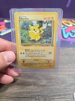 Front of Pikachu Base Set card in sleeve and toploader