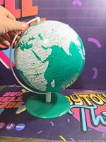 Front view of globe showing Africa, Europe, Asia on green base