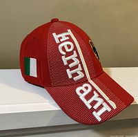 Left side view showing Ferrari embroidery, Italian flag patch, curved brim