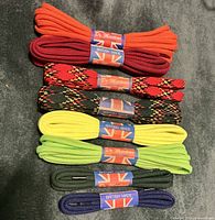 Stacked bundles of eight Dr. Martens laces showing colours, wrappers, and Union Flag branding