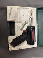 Opened case showing soldering gun, tips, wrench in molded tray