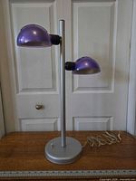 Full view of lamp showing base, stand, two purple shades, power cord