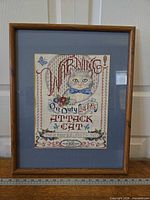 Full view of framed cross stitch with mat and frame