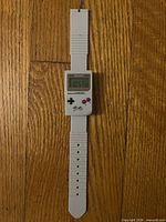 Front view of Nintendo Game Boy wristwatch showing LCD, buttons, and full strap
