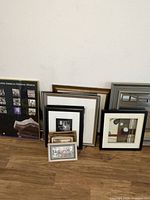 Group shot of all framed items leaning against wall