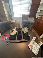 Group shot showing both totes, visor, fans, picture frame on table