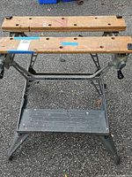 Front view of Black & Decker Workmate folding workbench showing wooden jaws, steel frame, foot step shelf