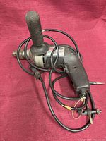 Full view of Craftsman corded drill with side handle and power cord