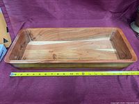 Rectangular solid wood tray with tape measure showing ~20 inch length