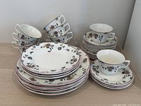 Stacks of plates and teacups showing pattern and quantity