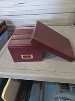 Burgundy photo storage box with lid removed showing label holder