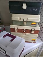 Stack of four tackle boxes showing size comparison and exterior condition