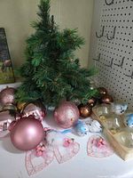 Tabletop tree with assorted ornaments spread around it