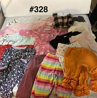 Group shot of assorted sleepers, bodysuits, pants and shirt
