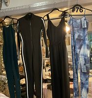 all four jumpsuits hanging on hangers