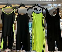 Front view of four unitards hanging on hangers showing color variations