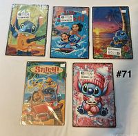 Front view of all five Lilo & Stitch metal signs