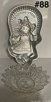Front view of Raggedy Ann cake pan with glass bowl beneath