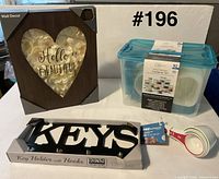 Group shot showing storage set, key holder, measuring cups and wall décor