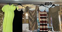 All five dresses hanging on rack
