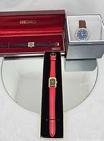 Overview of the three wristwatches with boxes