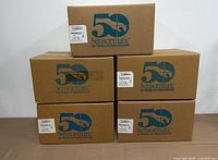Front view of five sealed Sensormatic boxes