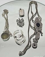 Entire jewellery set laid out showing both necklaces, earrings and two pendants