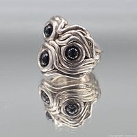 Front view showing organic silver swirl design with three onyx cabochons