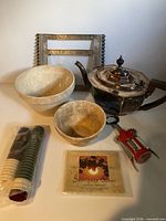 Group shot showing teapot, two basins, frame, wine corker, capsule rolls and label packet