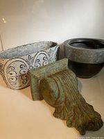 All three items: round zinc planter, rectangular ornate planter, green patina wall bracket