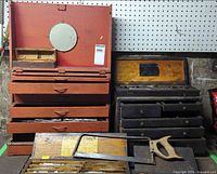 Overview of both wooden toolboxes, taps, dies, hacksaw in foreground