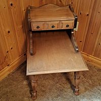 Front view of wooden side table with three drawers and lower shelf
