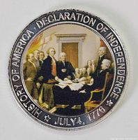 Front of commemorative coin displaying colour scene and rim inscriptions