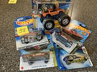Group shot of five sealed Hot Wheels packages with note 38