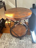 Top view of round wood plank table showing wear