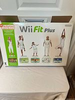 Front of Wii Fit Plus box showing branding and exercise images