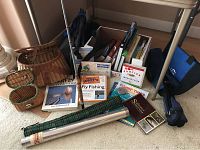 Overview of all items including two creel baskets, steel rod container, books, rods, and folding chair.